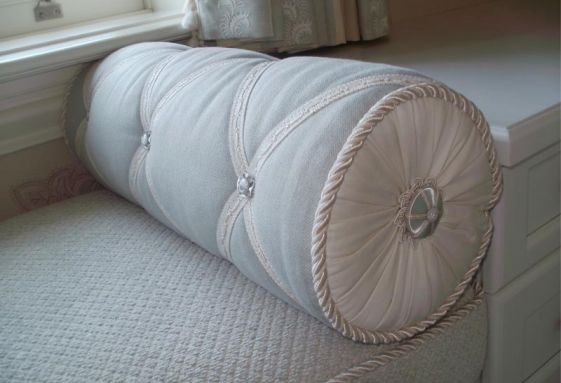 Custom-round-bolstered-cord-rosette-band-trimmed-pleated-ends-pillow